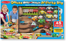 Load image into Gallery viewer, Melissa &amp; Doug Deluxe Multi-Vehicle Activity Rug (39.5" x 36.5") - 19 Vehicles, 12 Wooden Signs, Train Tracks
