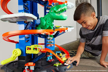 Load image into Gallery viewer, Hot Wheels City Ultimate Garage Track Set with 2 Toy Cars, Garage Playset Features Multi-Level Racetrack, Moving T-Rex Dino &amp; Storage for 100+ 1:64 Scale Vehicles, Toy Gift for Kids 3 Years &amp; Older